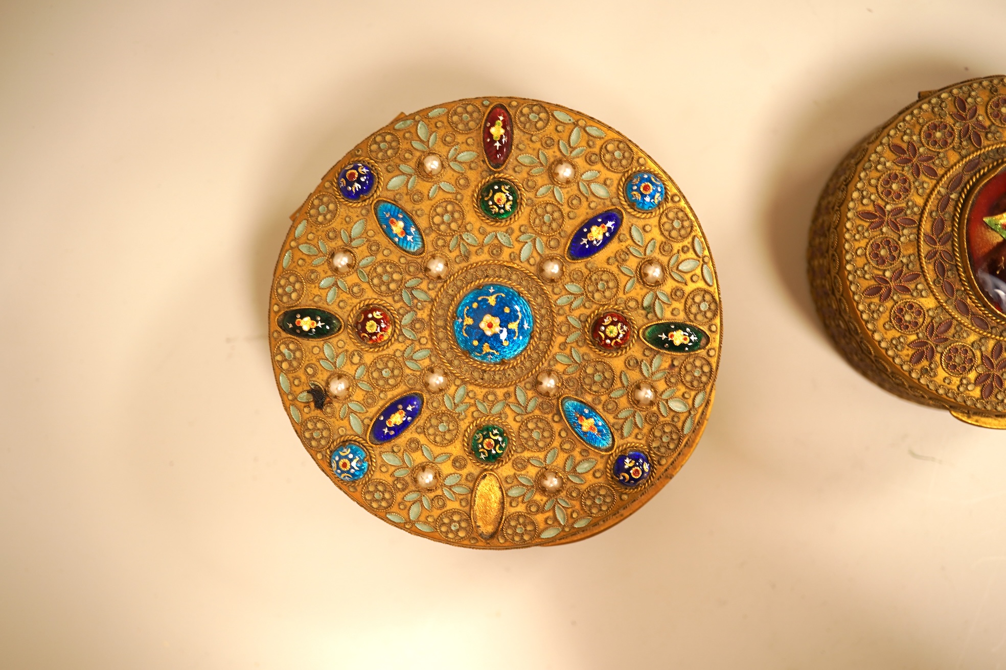 Two Limoges enamel mounted gilt filigree work circular boxes, largest 8cm diameter